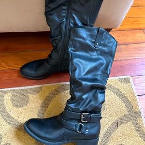 Black tall boots with silver hardware buckle